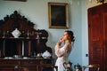 A bride in underwear and a white robe in the interior of a Villa in Italy at a wedding.morning of the bride in Tuscany.boudoir