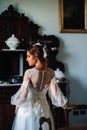A bride in underwear and a white robe in the interior of a Villa in Italy at a wedding.morning of the bride in Tuscany.boudoir