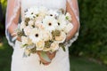 Bride holding her wedding bouquet of white flowers
