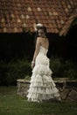 Bride in vintage dress looking back over her shoulder