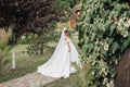 The bride in a voluminous white dress with open shoulders and a long veil Royalty Free Stock Photo