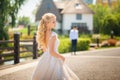 The bride is waiting for the groom before the meeting. Loving wedding couple in the summer on the square in the city of Dnipro, Uk Royalty Free Stock Photo