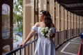 The bride waits with bated breath for the groom. Sexy bride in the parking lot.