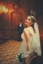 Bride waits for a groom in the hall of old theatre