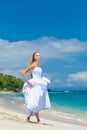 Bride walking along sea coast Royalty Free Stock Photo