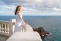 Bride walking along sea coast wearing beautiful wedding dress Royalty Free Stock Photo