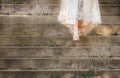 Bride walking down stairs in wedding dress Royalty Free Stock Photo