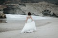 The bride walks alone on the beach Royalty Free Stock Photo