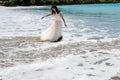 Oops! Unexpected wave makes bridal dress of bride wet and dirty