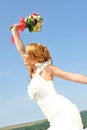Bride waving colorful posy Royalty Free Stock Photo
