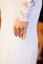 A bride wearing a beautiful and luxury wedding ring on her left hand.