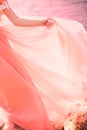 The bride is wearing a wedding dress gently coral color on the sea Royalty Free Stock Photo