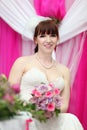 Bride wearing white dress holds bouquet Royalty Free Stock Photo