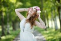 Bride wearing a wreath of peonies dancing in the alley