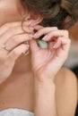 Bride wears an earring, close-up Royalty Free Stock Photo