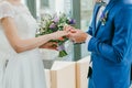 Bride wears a ring on groom`s finger Royalty Free Stock Photo