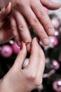 The bride wears the ring to groom`s finger at wedding day. Love, happy marry concept. Christmas concept.