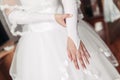Bride wears wedding gloves