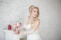 Bride with wedding bouquet standing near fireplace Royalty Free Stock Photo