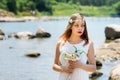 Bride with wedding crown and bouquet of seashels