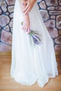 The bride in a wedding dress with a bouquet of flowers.