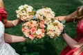 bride in wedding dress and bridesmaids red dressing holding Wedding bouquets on ceremony