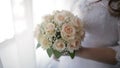 Bride in wedding dress holding beautiful white wedding flowers bouquet. Royalty Free Stock Photo