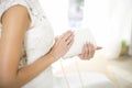 Bride in a wedding dress holds in hand a white bag. Beautiful manicure. Wedding day. Wedding rings Royalty Free Stock Photo