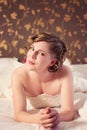 Bride in a wedding dress lies on bed Royalty Free Stock Photo