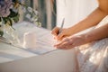 the bride in a wedding dress signs in the contract Royalty Free Stock Photo