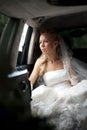 Bride in wedding dress sits in limousine Royalty Free Stock Photo