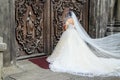 Bride in wedding dress and veil outside church doors