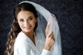 Bride with wedding makeup and hairstyle. Fashion bride. Attractive bride in white robe in wedding morning. Royalty Free Stock Photo