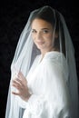 Bride with wedding makeup and hairstyle. Fashion bride. Attractive bride in white robe in wedding morning. Royalty Free Stock Photo