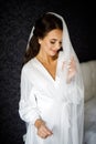 Bride with wedding makeup and hairstyle. Fashion bride. Attractive bride in white robe in wedding morning. Royalty Free Stock Photo