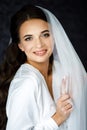Bride with wedding makeup and hairstyle. Fashion bride. Attractive bride in white robe in wedding morning. Royalty Free Stock Photo