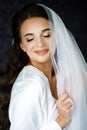 Bride with wedding makeup and hairstyle. Fashion bride. Attractive bride in white robe in wedding morning. Royalty Free Stock Photo