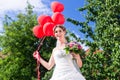 Bride at wedding with read helium balloons Royalty Free Stock Photo