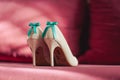 Bride wedding shoes with high heels and silver brilliant earrings on sheep`s clothing Royalty Free Stock Photo