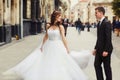 Bride whirls behind a groom smiling to him