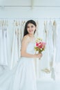 Bride in white dress holding a bouquet on hand for wedding,Beautiful asian woman smiling and happy,Romantic and sweet moment Royalty Free Stock Photo