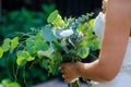 Bride in white dress holding in his hand a Bridal bouquet of roses on the flowers, wedding Royalty Free Stock Photo