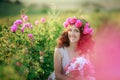 A bride in a white dress holds a bouquet of roses and callas on the background of green grass. Royalty Free Stock Photo