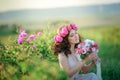 A bride in a white dress holds a bouquet of roses and callas on the background of green grass. Royalty Free Stock Photo