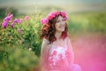 A bride in a white dress holds a bouquet of roses and callas on the background of green grass. Royalty Free Stock Photo