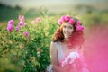 A bride in a white dress holds a bouquet of roses and callas on the background of green grass. Royalty Free Stock Photo