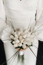 the bride in a white dress holds a wedding bouquet close-up Royalty Free Stock Photo