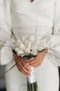 the bride in a white dress holds a wedding bouquet close-up Royalty Free Stock Photo