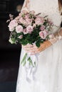 the bride in a white dress holds a wedding bouquet in her hands Royalty Free Stock Photo