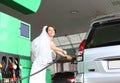 Bride white dress refuels car gas station Royalty Free Stock Photo